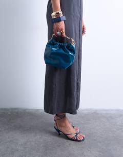 Model wearing Gabriette metal trim handle grab bag in teal