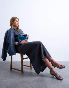 Model wearing Gabriette metal trim handle grab bag in teal