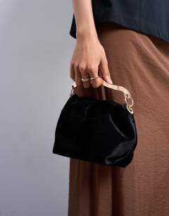 Model wearing Gabriette small velvet metal trim handle grab bag in black