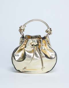Model wearing Gabs ruched drawstring bell bag in gold