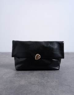 Model wearing Gaia folded clutch bag with hardware in black