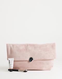 Model wearing Gaia oversized suedette clutch bag with hardware in light pink