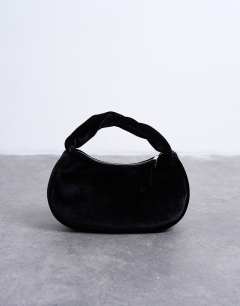 Model wearing Gail twist handle velvet grab bag in black