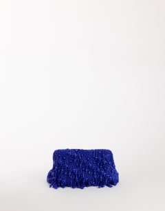 Model wearing Garison bead and embellished clutch in cobalt