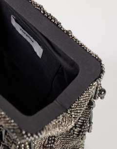Model wearing Garison bead and embellished clutch in pewter