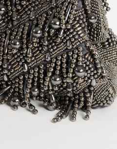 Model wearing Garison bead and embellished clutch in pewter