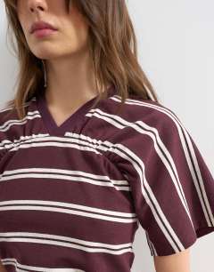 Model wearing Gather yoke seam short sleeve top burgundy stripe  