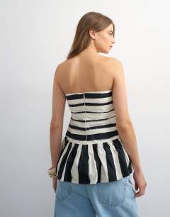 Model wearing Gathered bust bandeau with peplum hem in mono stripe