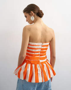 Model wearing Gathered bust bandeau with peplum hem in orange stripe