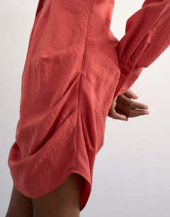 Model wearing Gathered skirt mini shirt dress in rust