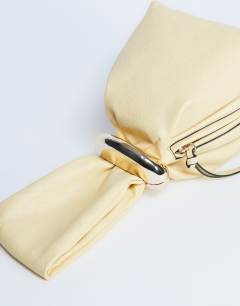 Model wearing Gee mini hardware grab bag in lemon