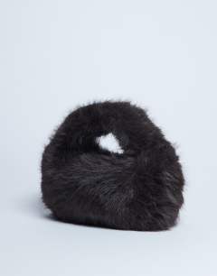 Model wearing Gemima faux fur grab bag in chocolate