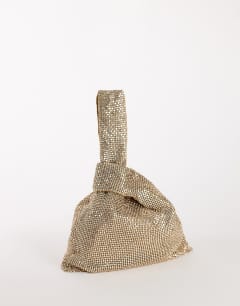 Model wearing Gemma small diamante grab bag in gold with clear stones