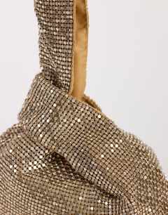 Model wearing Gemma small diamante grab bag in gold with clear stones