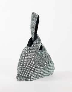 Model wearing Gemma small diamante grab bag in silver with dark green stones
