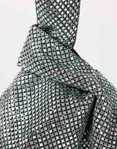 Model wearing Gemma small diamante grab bag in silver with dark green stones
