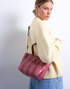 Model wearing Gemma stripe faux leather grab bag in pink and brown