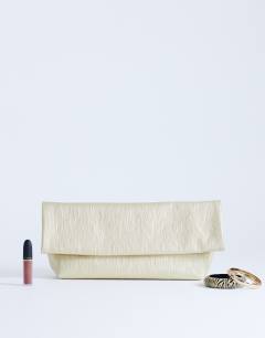 Model wearing George clutch bag in gold