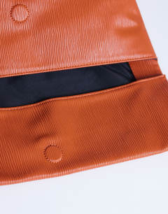 Model wearing George clutch bag in rust