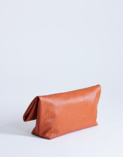 Model wearing George clutch bag in rust