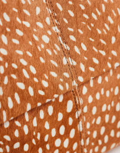 Model wearing George oversized clutch bag in deer print