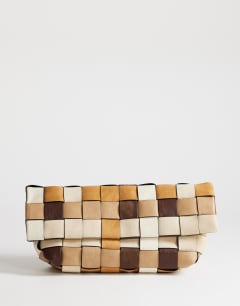 Model wearing George oversized clutch bag in neutral weave mix