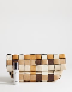 Model wearing George oversized clutch bag in neutral weave mix