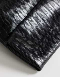 Model wearing George weave oversized clutch bag in black