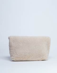 Model wearing Georgia folded borg clutch grab bag in beige