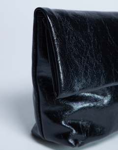 Model wearing Georgia folded clutch grab bag in black