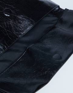 Model wearing Georgia folded clutch grab bag in black