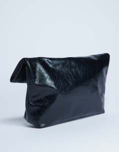Model wearing Georgia folded clutch grab bag in black