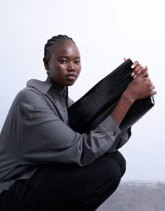 Model wearing Georgia folded clutch grab bag in black
