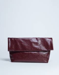 Model wearing Georgia folded clutch grab bag in burgundy