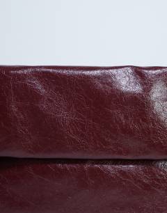 Model wearing Georgia folded clutch grab bag in burgundy
