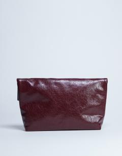 Model wearing Georgia folded clutch grab bag in burgundy