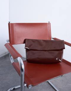 Model wearing Georgia folded clutch grab bag in chocolate patent