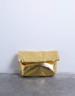 Model wearing Georgia folded clutch grab bag in gold