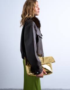 Model wearing Georgia folded clutch grab bag in gold