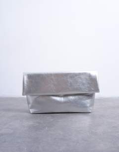 Model wearing Georgia folded clutch grab bag in silver