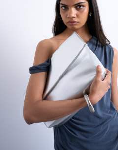 Model wearing Georgia folded clutch grab bag in silver