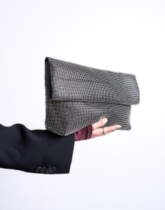 Model wearing Georgia folded clutch grab diamante bag in black