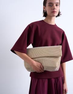 Model wearing Georgia folded clutch grab diamante bag in gold
