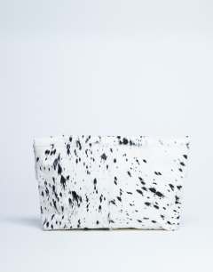 Model wearing Georgia hair on leather folded clutch grab bag in dalmatian