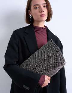 Model wearing Georgia large folded clutch grab diamante bag in black