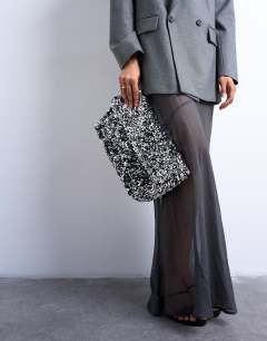Model wearing Georgia large folded clutch grab sequin bag in silver