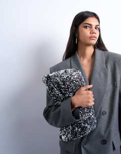 Model wearing Georgia large folded clutch grab sequin bag in silver