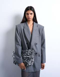 Model wearing Georgia large folded clutch grab sequin bag in silver