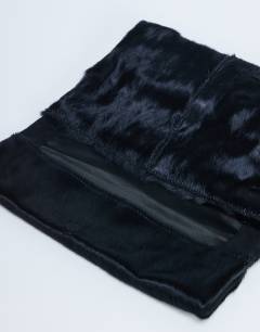 Model wearing Georgia leather folded clutch grab bag in black pony