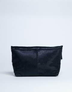 Model wearing Georgia leather folded clutch grab bag in black pony
